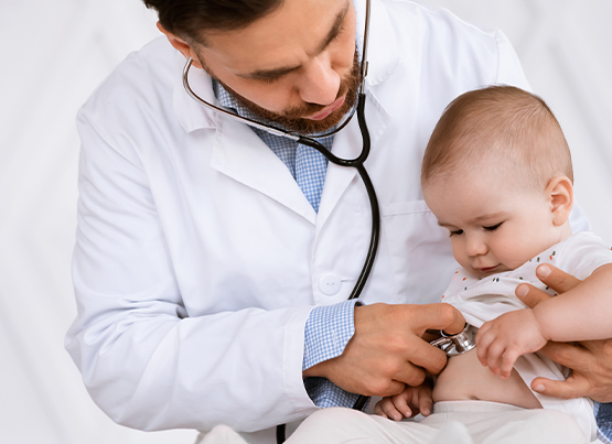 doctor with a stethoscope on the baby