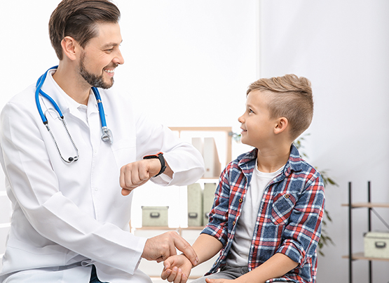 doctor examining a child by testing heart rate